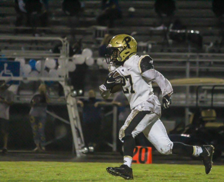 Running down the field, return man EJ Crawford prepares to escape the defenders. The varsity football team will face Sickles High School on Friday, Sept. 25. 