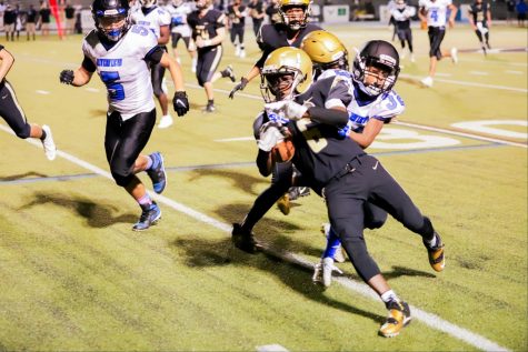 Running down the sideline, the ball carrier tries to avoid a Riverview defender. The junior varsity football team defeated their four opponents by a combined 119-6.