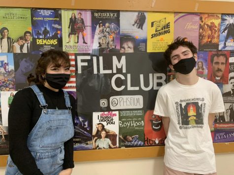 Standing next to the film club board in main hall, co-presidents Alexa Semmelmann and Owen Felton talk about their time with the film club. Film club consists of monthly meetings to talk about influential films.