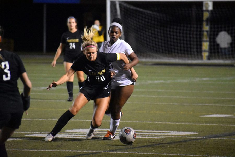 Defending the ball, senior left back Claire Rain carries the ball downfield to the Wharton goal, Nov. 17 at Dad’s Stadium. The team defeated Wharton 3-0. 