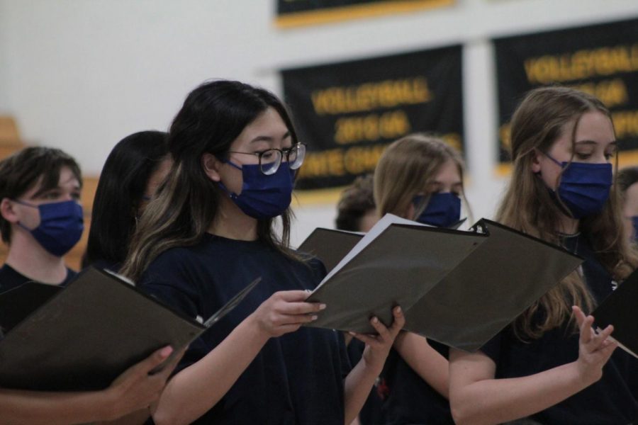 Reading her music, junior Ashley Cheung performs with Varsity Chorale. Cheung has participated in for all three years of her high school career.