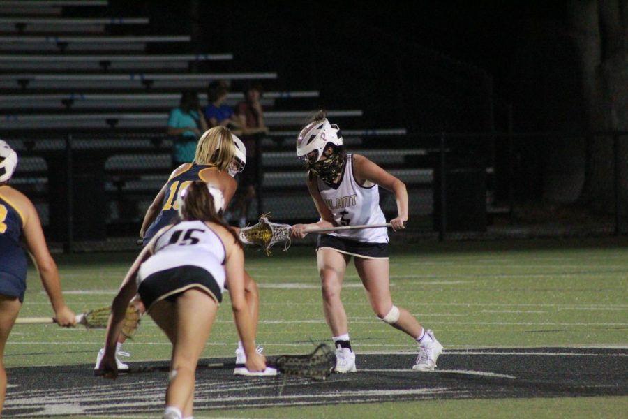 Standing at midfield senior Caroline Patterson prepares for the faceoff. The girls won their district and moved on to regionals to face Steinbrenner High School.