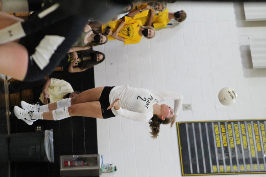 Setting the ball, senior Lily Frierson hits the ball across the net. Plant won against Calvary 3-0 on Sept. 9.