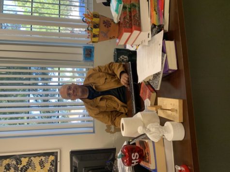Sitting at his desk, English teacher Joshua Marr poses for  photo. Marr has been working at Plant since 2000 teaching a variety of English courses.