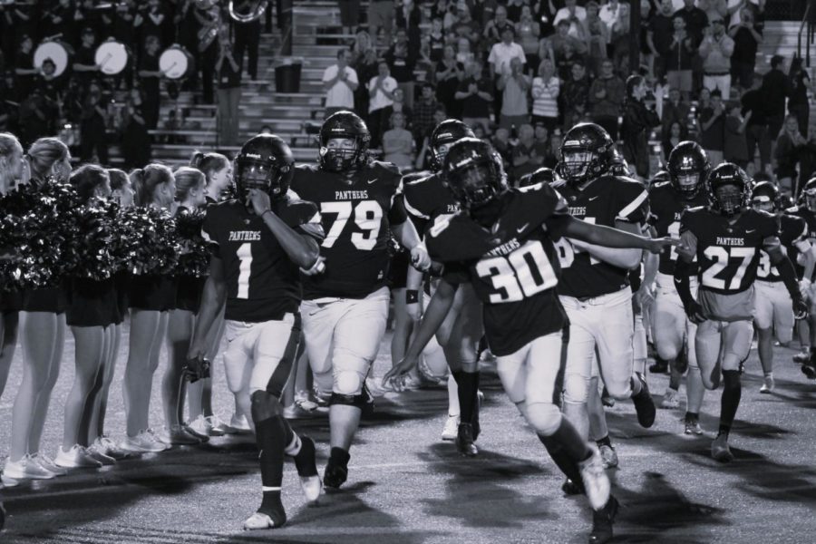 Storming the field at the last home game of the season, senior Kervens Duvermond runs out leading the team. The Panthers winning record so far in the season of 6-3 might allow them to earn a spot in the playoffs this year.