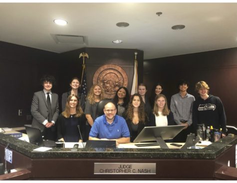 Judge Christopher Nash, with the co-captains- Luke McLaughlin and Kate Bentley, and the rest of the team posing for the camera while in Judge Nash’s courtroom at the George Edgecomb Courthouse. The team participated in the Empire Mock Trial Competition, and placed 13th.