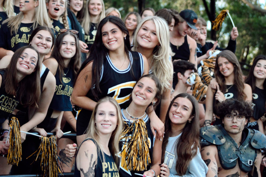Students who are a part of Plant High’s Gold Rush club smile in the stands to support their fellow classmates at the Plant vs. Jesuit lacrosse game. This is a highly anticipated game that many look forward to all year long.  