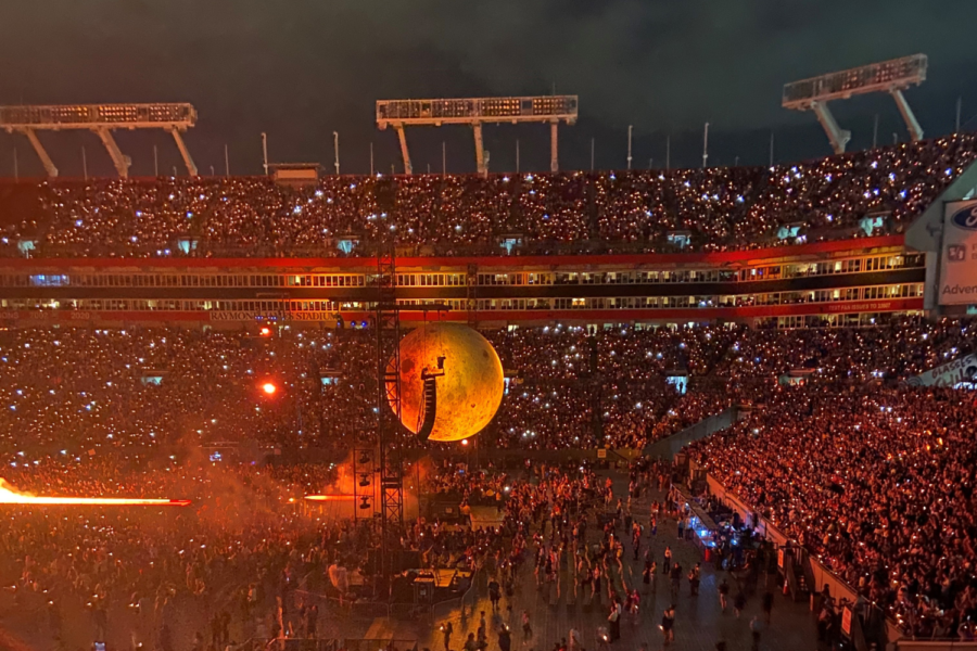 The+prop+moon+at+The+Weeknd+concert+in+Raymond+James+Stadium+turns+orange+during+his+hit+song+Blinding+Lights.+In+the+background+you+can+see+many+fans+with+their+flashlights+on%2C+swaying+to+the+music.+