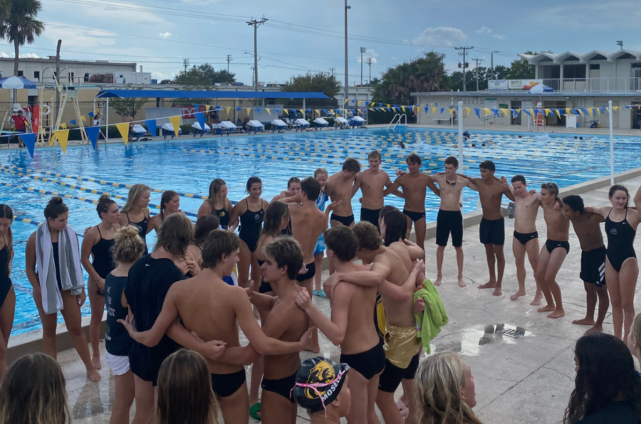 Plant Swim Team circles up for their pre-game chant.