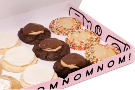The Crumbl box has text on the side of their cookie box statin “nom” repeatedly. This is what you will receive when you order or pick up your cookies from any Crumbl locations with their flavors of the week. 