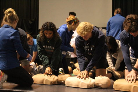 Juniors Tanner Swank and Moriah Scott performing the stimulatory hands-on CPR training in the auditorium, on February 13. A fairly recent bill signed by Gov. Ron DeSantis requires Florida high school students to attend cardiopulmonary resuscitation training as a form of graduation requirement 