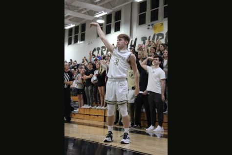 Standing with his arm raised, Senior Shane Schuster just drained a three point shot in front of the PHS Gold Rush. The Panthers went on to defeat Jesuit 51-48 in a comeback win.