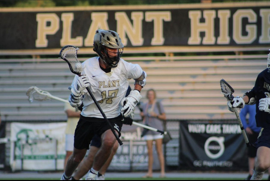 Carrying the ball in his stick, Senior Leif McGraw has just won the face and is pushing the offensive possession. Boy Lacrosse defeated Newsome in the District Championship on Thursday, April 13. 