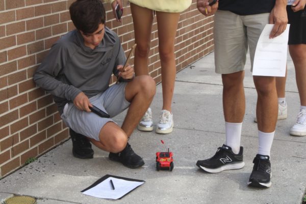 Students in Mr. Brockman’s third period record and measure their Tumble Bug’s measurements. This was the first day of experiments and the Great Tumble Bug Race was the next Tuesday. 