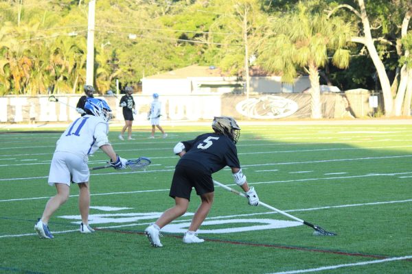 Reese Lewis, a Junior, sets up for the next play of the game. They played Jesuit on April 5.  