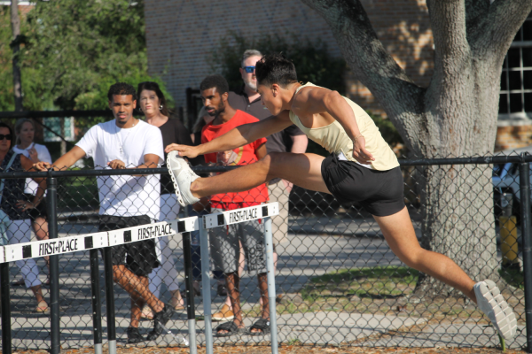 Senior Alex Sanchez leaped over his first hurdle to lead the race. Sanchez will go on to win his hurdle event.