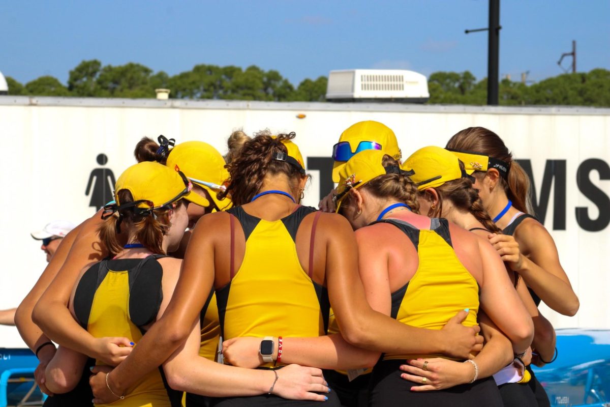 The Women’s 2V8+ huddles together before racing at FSRA Sweeping State Championships. The group gave each other encouraging words and got one another excited before the race.