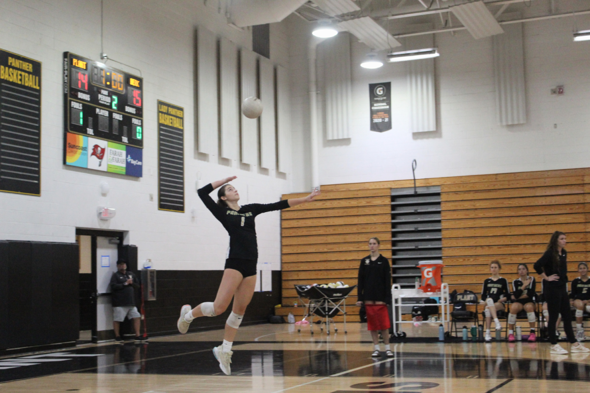 Lara Matta, 12, prepares to serve against the Berkeley Buccaneers. Matta’s serve helped Plant get a block to stop Berkeley from scoring a point. 