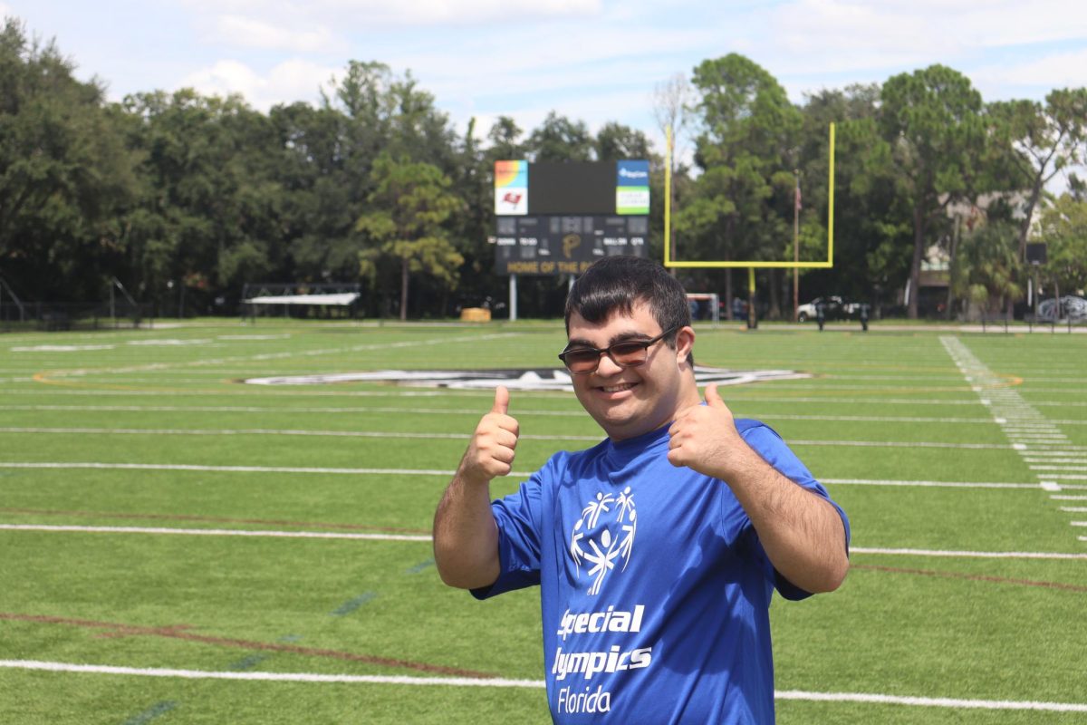 Special Olympics athlete, Nick (12), smiles at the camera. Special Olympics started their fall flag football season on Sept. 9.