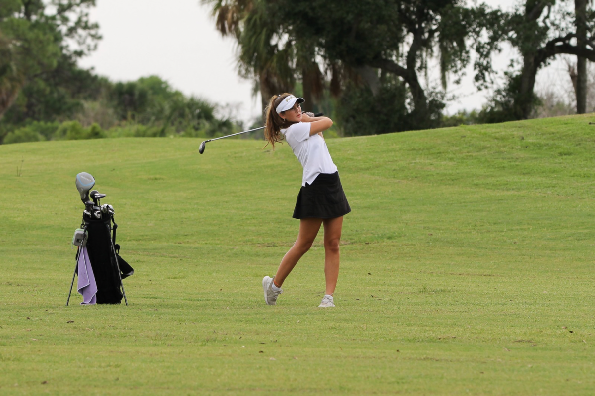 Georgi McGonnigal, 11, looks for her ball as she finishes her golf swing. McGonnigal shot a round of 49 on Thursday.