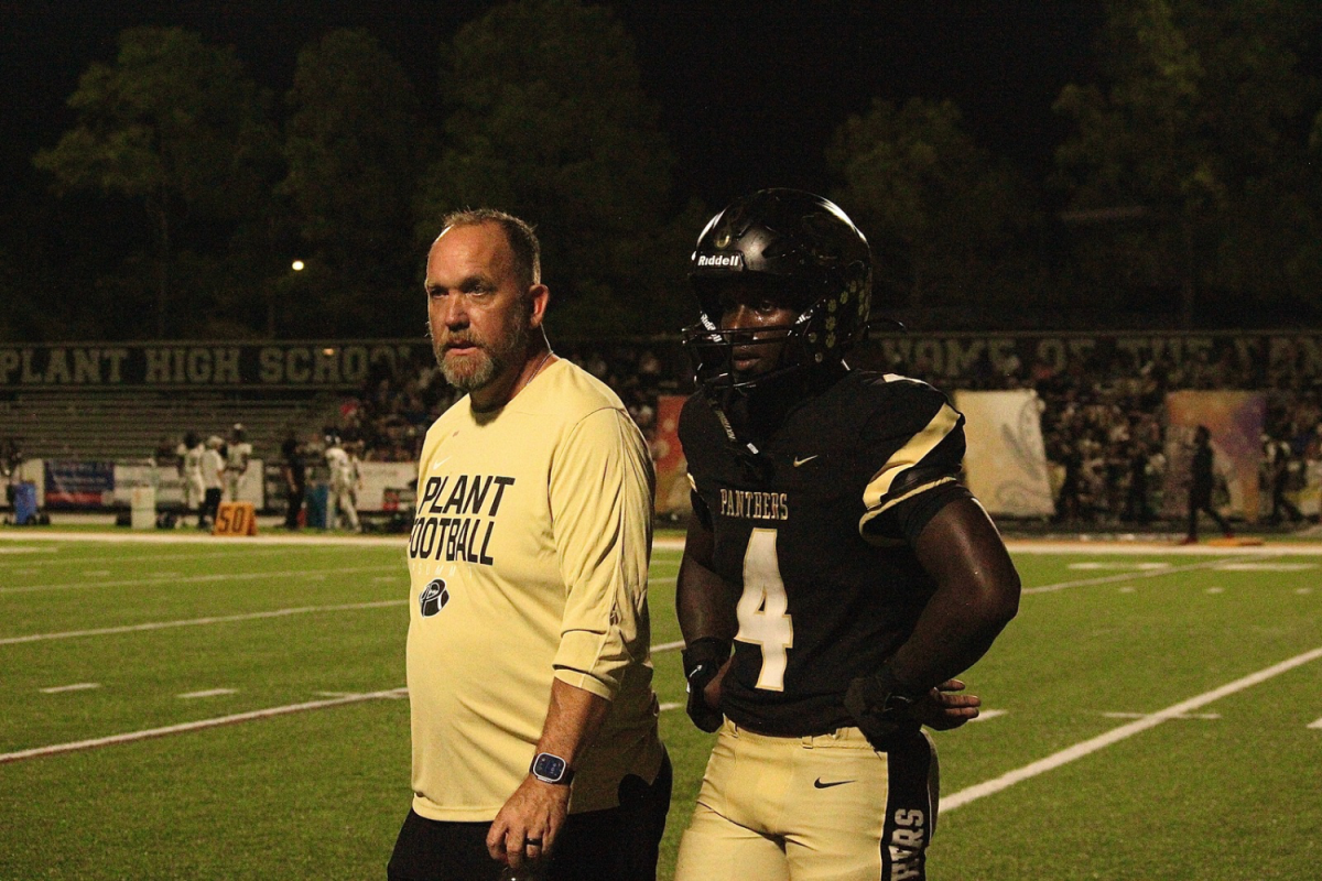 Waltez Clark, a senior, and Hank Brown converse between plays. They later discussed the next move.