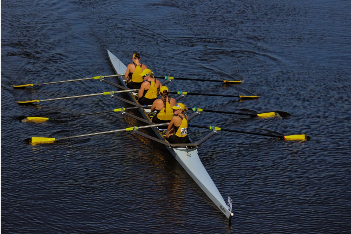 The girls' varsity quad father rows through the finish line. That was their last race of the day.