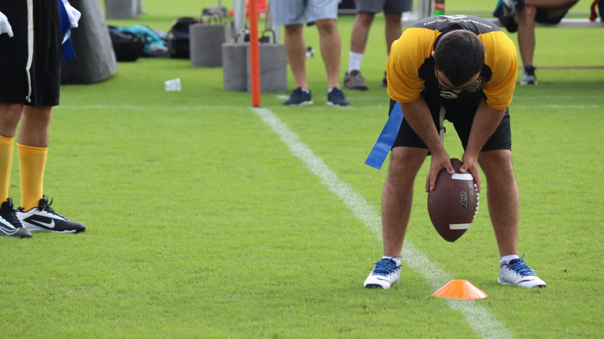 Athlete, Nick Varjabedian, prepares to set the ball while at the Special Olympics states tournament in Orlando. The team was second in the state for flag football, the first time in Plant history.