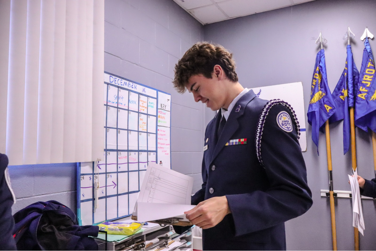 Mungzliner pulls out papers to give to a cadet. He helped them situate their items for an assignment.
