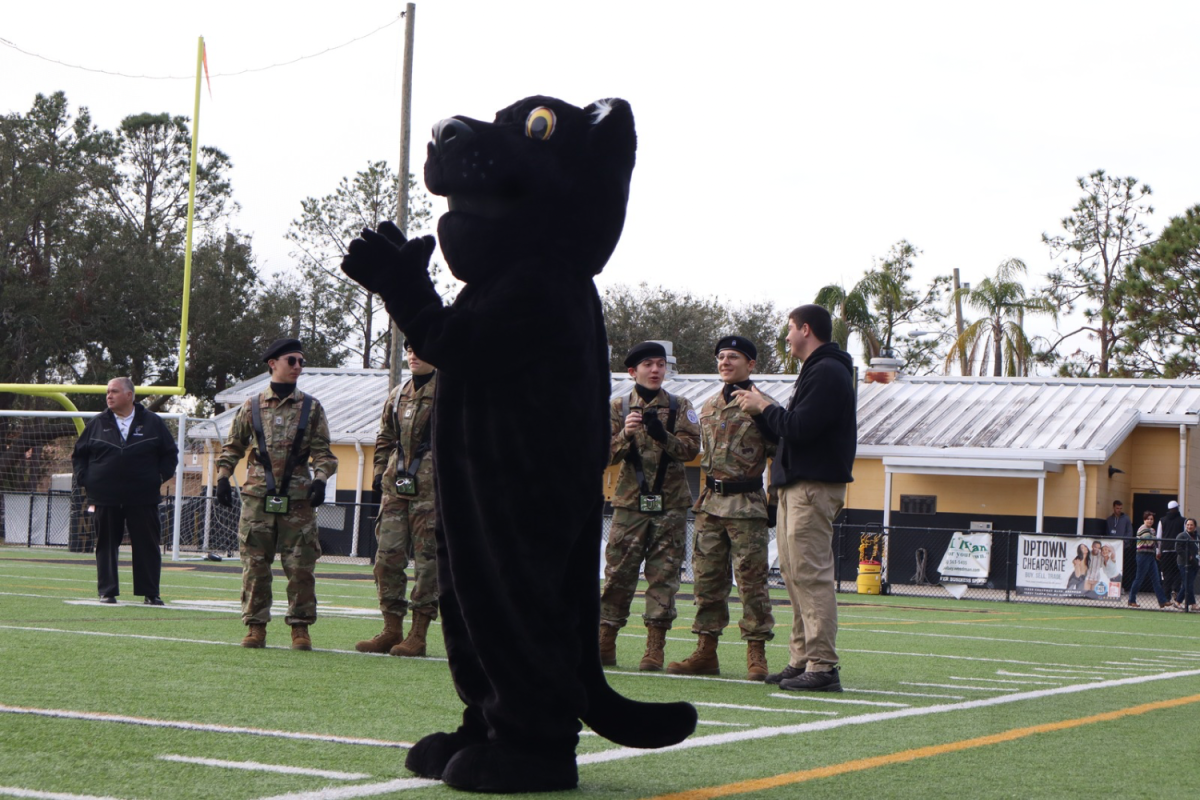 Patty the Panther claps as the step team preforms their routine for the student body. Patty came out to show support and spirit for the Pep Rally.