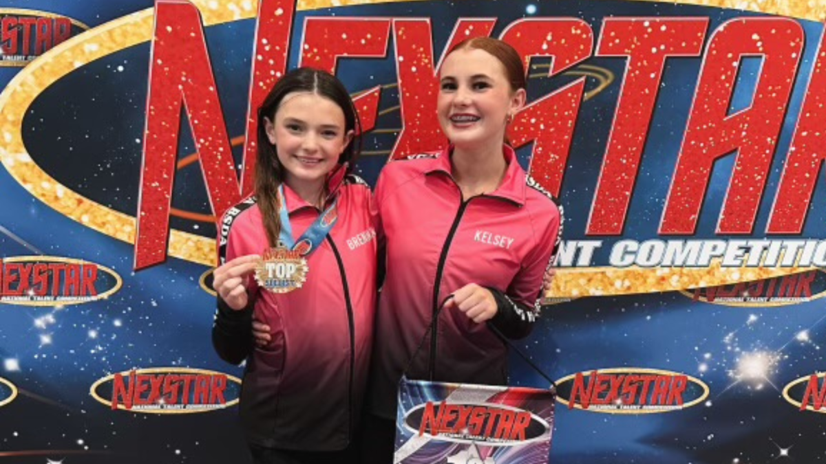 Kelsey Radigan (10) and her sister Brennan Radigan smile after winning first place in their respective dance competitions. Radigan has been dancing since she was four years old.