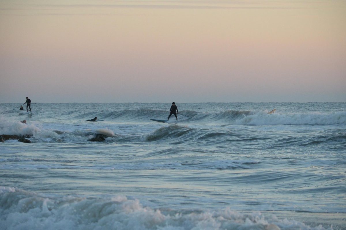 A paddle-boarder drops into a closeout at Sunset Beach. Paddle-boards are a popular option for Gulf Coast surfers due to their high volume measurements.