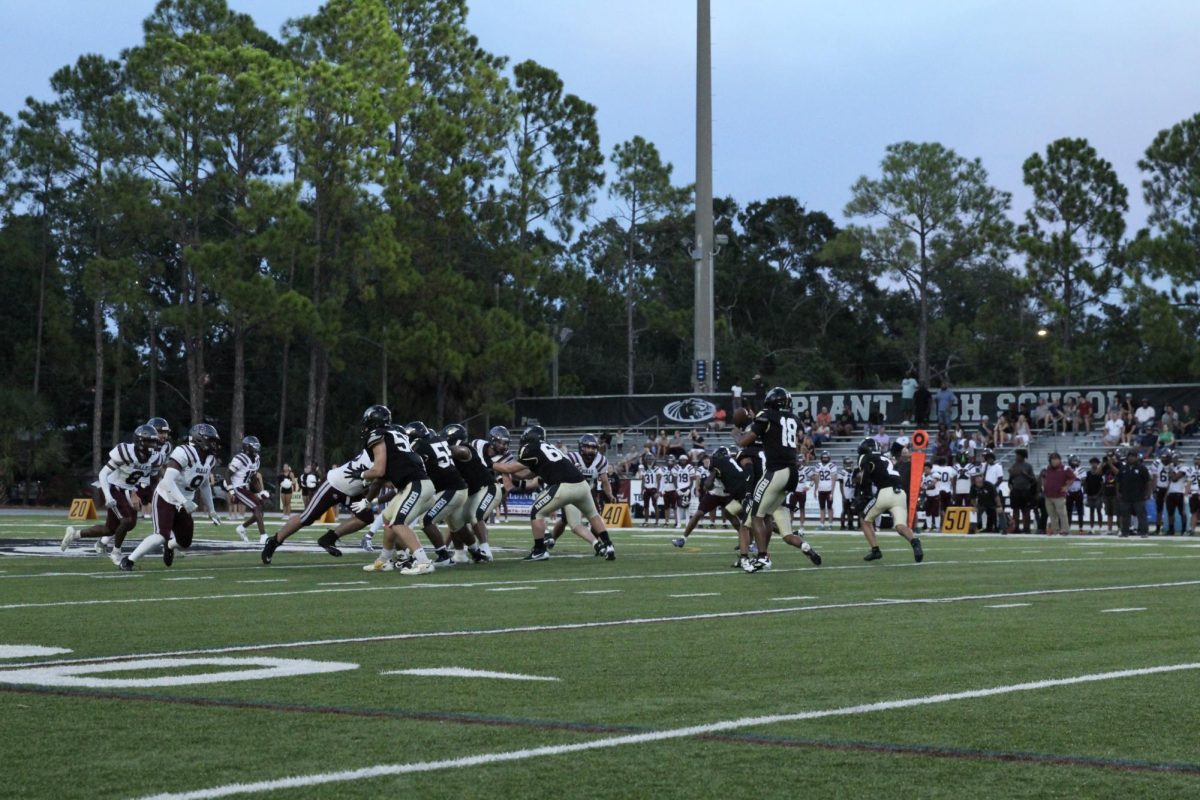Dillon Rose Bailey (12) is passing the ball to Darryon Williams (12), hoping to score. This touchdown created a play that would later lead to a 28-20 victory.