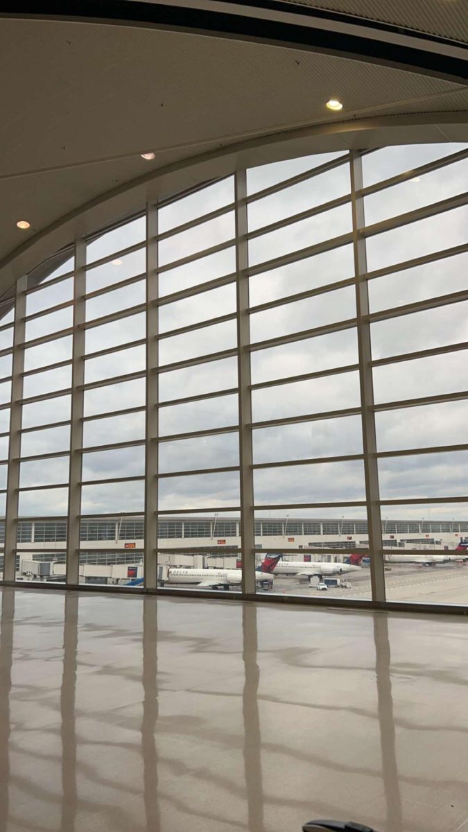 Stella Griggs (12) captures an image of the tarmac at Detroit International Airport. The airport saw more than 33 million passengers in 2024.  