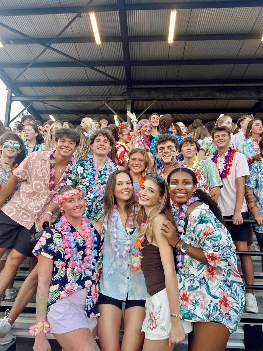 The Gold Rush Board gets hype for the football game against Wiregrass Ranch. Beforehand, the board handed out leis to students as they were arriving.