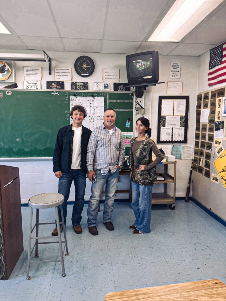 Brooke Cohen (11) and Tristan Sears (11) pose with Mr. Ferlita during Teachers vs. Students Day. Mr. Ferlita said he felt appreciated by his students.