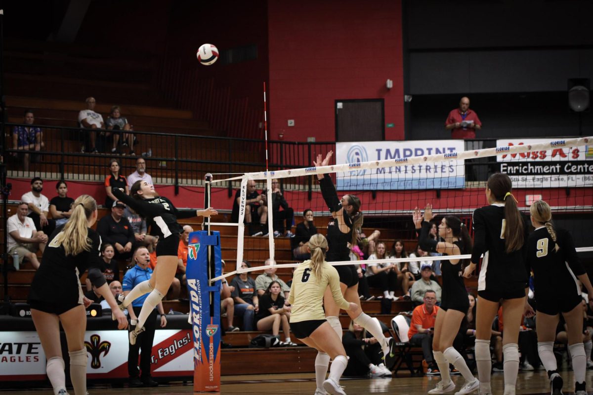 Kate Mitchell Compton (12) leaps, ready to spike the ball onto Winter Park's court during the finals. She scored a point for her team, even though they ultimately lost the match.  