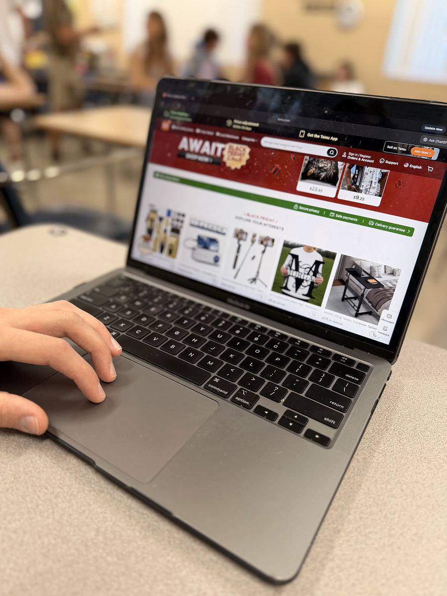 A student looks on Temu trying to find new deals for Black Friday. Temu was created as a sales platform that sells a variety of items for very low prices. 