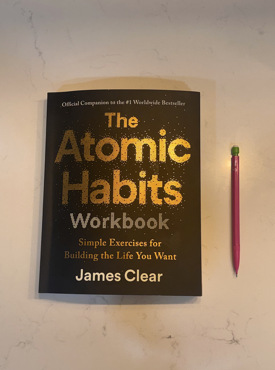 The Atomic Habits workbook sits beside a pencil waiting to outline the step-by-step strategies for building and breaking habits. The book helped emphasize how small, consistent actions can lead to long-term personal change.
