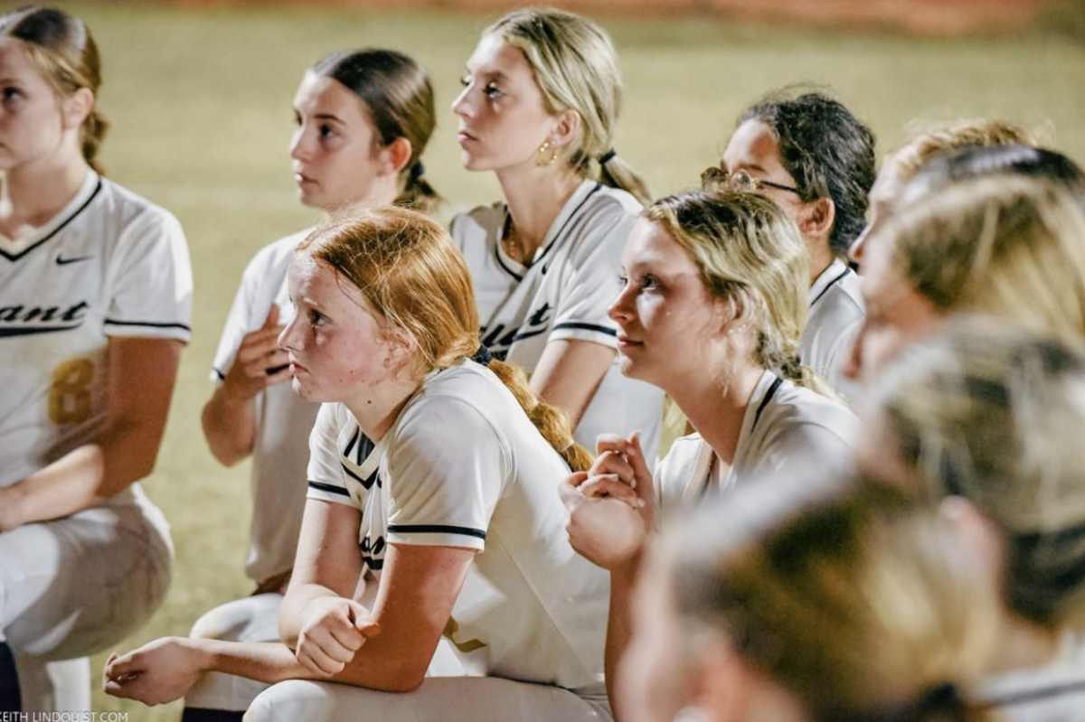 The 2024 girls softball team gathers around and takes a knee as part of their pre-game tradition. In these meetings, the girls discussed a game plan and had the opportunity to devote time to observe any practices of worship towards their religion.  