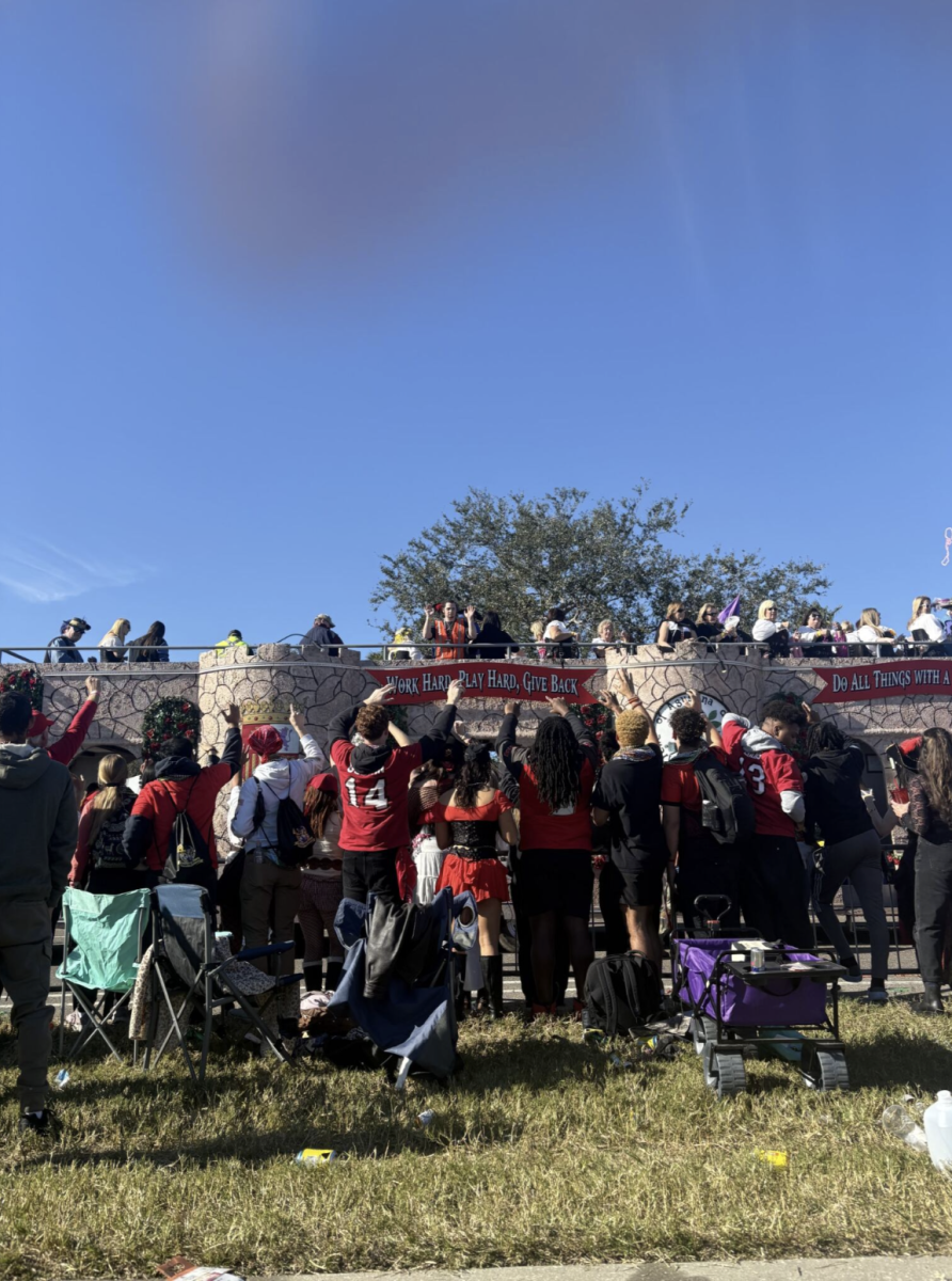 Many people line up against the fence to catch as many beads as possible during the parade. Collecting beads was a long-standing and one of the most popular Gasparilla traditions. 