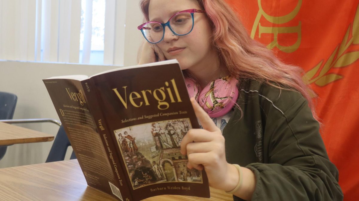 Izzy Pasagian (12) studies from her AP Latin textbook. The widespread availability of AP classes at Plant High School has led students to take AP-heavy schedules, creating a myriad of effects. 