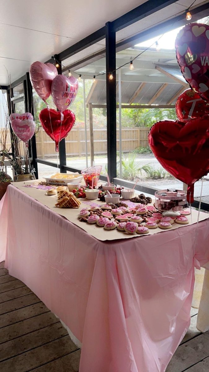 A spread of Valentine's balloons and snacks creates a nice setting for friends to spend time with each other for Galentine's. Students designed the table together and each person brought a snack. 