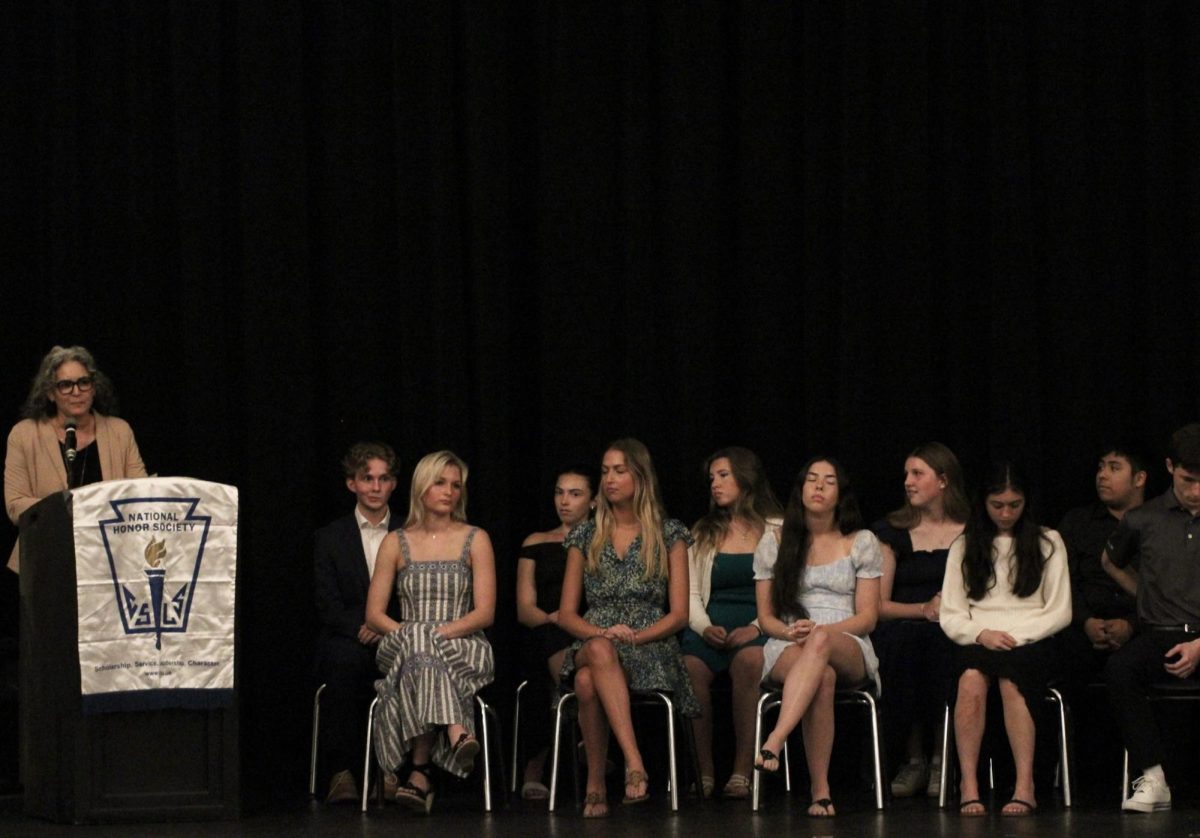 Principal Heather Holloway, speaks to the crowd of inductees at the National Honors Society Induction. Board members of NHS prepared for this induction for weeks.  
