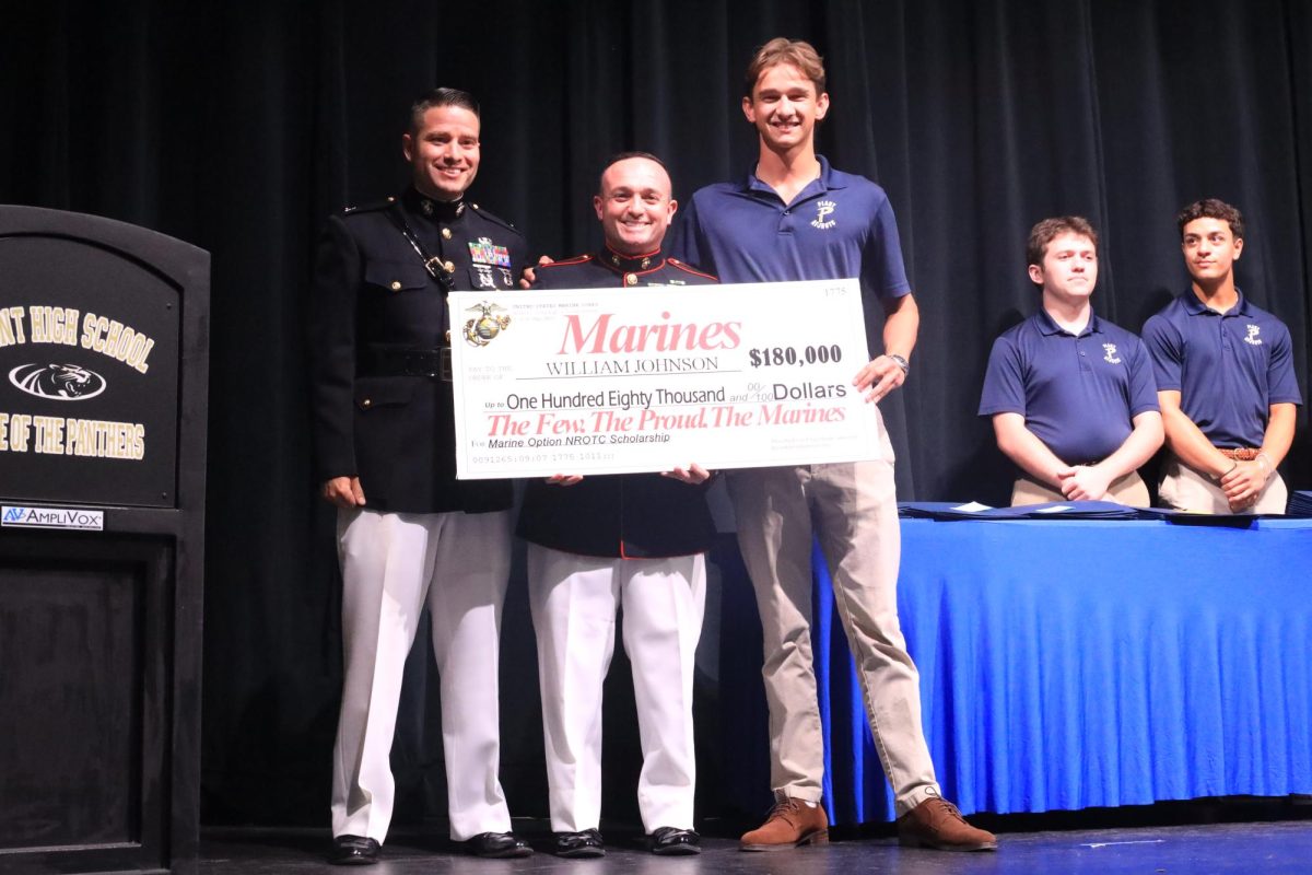 Senior Henry Johnson receives a scholarship from the United States Marines for his efforts in Plant's NROTC. Johnson decided to use the money to attend The Citadel in the fall.