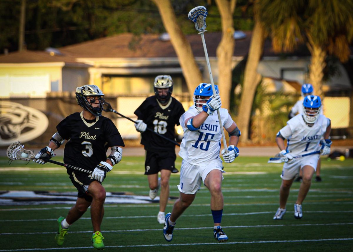 Sophomore Armani Gallegos rushes by Jesuit offense on a attempt to score a goal. The Panthers ultimately lost with a final score of 15-7.