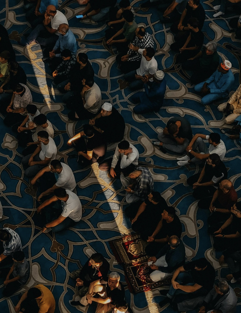A group of people gathered together to pray as a community. Humans have historically turned religion to make sense of what they cannot fully see or understand.