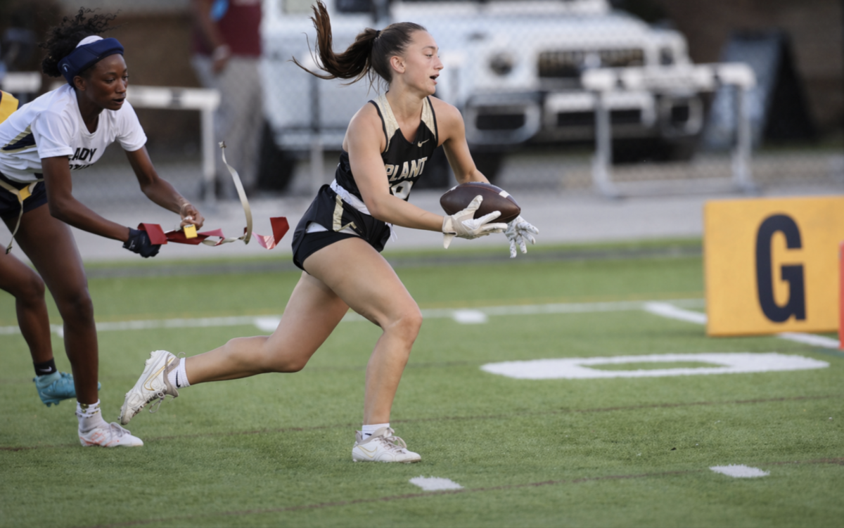 Junior Emma Sullivan runs toward the end zone after catching a pass from quarterback Reese Pittman. Sullivan accumulated six touchdowns throughout the season.